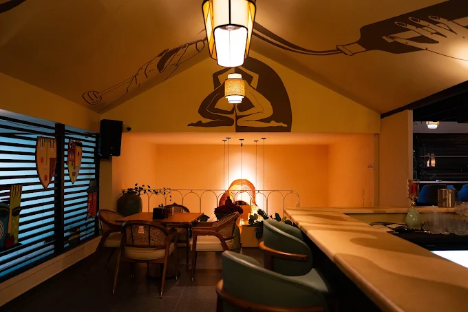 The bar at Stories Brew Garden, Yelahanka, with pendant lighting and seating