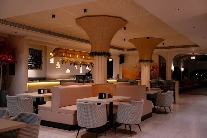 The lounge seating area with upholstered chairs and cane columns