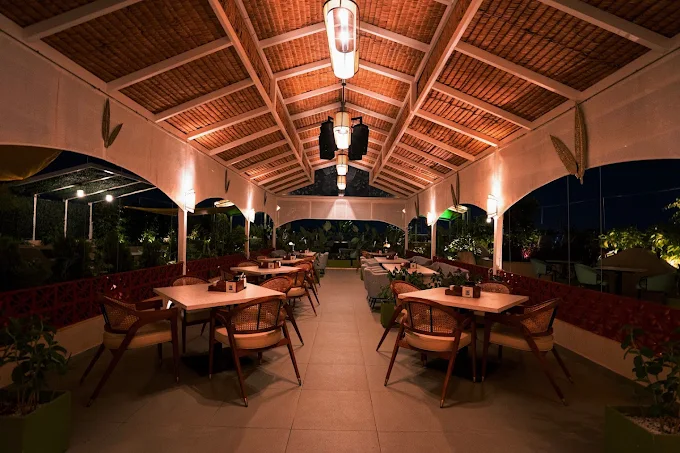 Rooftop dining tables at Stories Brew Garden, Yelahanka, lit for the evening