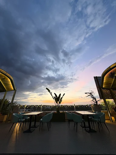 The open-air rooftop at Stories Brew Garden under a deep dusk sky